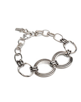 Chunky sculptural collar necklace in sterling silver, featuring oversized loops and a thick metal band.
