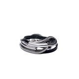 Layered black leather and snake chain wraparound bracelet with a silver malleable bangle, featuring a magnetic closure.