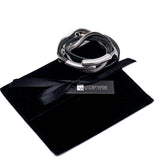 Layered black leather and snake chain bracelet with a silver bangle on a black velvet pouch, showcasing a magnetic closure.