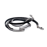 Layered black leather and metal snake chain bracelet featuring a silver bangle, designed for wraparound wear.