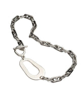 Chunky stainless steel necklace featuring an irregular abstract pendant and T-bar clasp, with a bold anchor chain design.