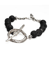 Chunky black lava stone choker necklace featuring a large silver T-clasp toggle, showcasing raw textures and bold design.