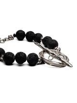 Chunky black lava stone choker necklace featuring large beads and an oversized silver T-clasp toggle closure.