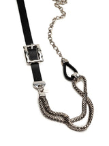 Chunky black leather choker with a large metallic buckle and fluid steel snake chains, showcasing a bold punk rock aesthetic.