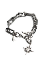 Silver chain bracelet with a star charm on a white background