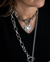 Chunky steel chain choker with a tiger head pendant paired with a long snake chain necklace, worn together.