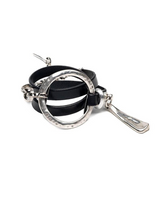 Bold wrap leather and metal statement cuff bracelet featuring multiple strands of black leather and sculpted silver-plated metal.