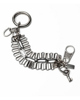 Stacked chunky stainless steel bracelets featuring link chains, a loop buckle, and a key pendant for an edgy look.
