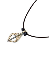Metallic arrowhead pendant on a black cord against a white background