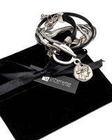 Set of silver bracelets with a black ribbon on a black box, branded 'Otherwise'.