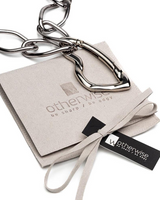 Silver chain necklace on a branded box with 'otherwise' packaging.