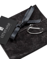Sterling silver plated two-finger ring displayed on a dark suede pouch with a ribbon, showcasing its unique geometric design.