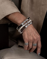 Zamak metal leather cuff bracelet with spring opening, featuring stacked design in white and black leather.