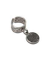 Silver ring with intricate design and a round pendant on a white background