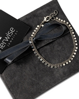 Elegant 999 silver antique plated anklet with round charms, displayed with a black suede pouch and ribbon.