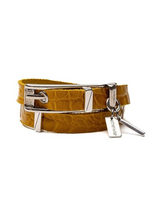 Striking yellow leather wrap bracelet with a bold buckle and accompanying silver-toned bangle, showcasing a textured finish.