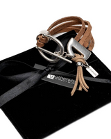 Brown leather bracelet with silver clasp on a black box with 'otherwise' brand tag.