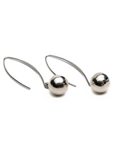 Pair of silver hoop earrings with spherical ends on a white background
