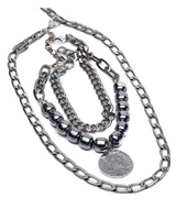 Edgy layered necklace set featuring dark semi-precious beads and stainless steel chains in a stacked style.