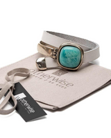Bracelet with turquoise stone on a branded pouch, with 'OtherWise' tag visible.