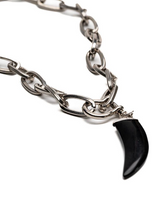 Chunky steel chain necklace featuring a black agate tooth pendant and U-bolt shackle, with an elegant design.