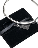 Layered silver choker set featuring a chunky ball chain and hammered loop pendant, presented on a black suede pouch.