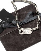 Silver keychain with a tag on a gray surface, branded 'otherwise'.