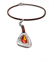 Necklace with a teardrop-shaped pendant featuring a red gemstone on a white background