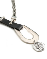 Close-up of a belt with a silver buckle and pendant on a white background