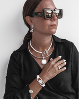Three-piece Silver Lava Necklace Set featuring a lava stone choker, layered silver-plated necklace, and adjustable bracelet.