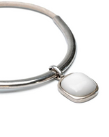 Chunky silver bracelet with a white resin pendant; modern design, polished finish, and sturdy construction.