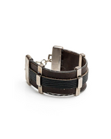 Black leather bracelet with silver accents on a white background