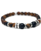Bracelet with wooden and black beads on a white background