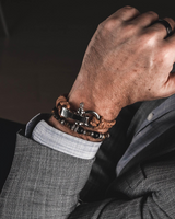 Person wearing a bracelet on a dark background