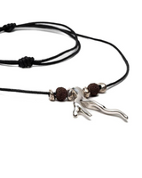 A black cord necklace featuring a polished silver-toned branch-like pendant, accented by two dark brown textured beads and small silver spacer beads, shown on a plain white background.