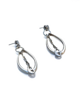 Pair of silver teardrop earrings on a white background
