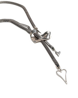 Silver chain necklace with a bow and heart pendant on a white background