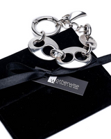 Chunky silver plated anchor link necklace and bracelet set displayed on a black suede pouch with a ribbon.