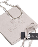 Dainty 999 silver antique plated anklet with charm drops, displayed on a beige suede gift pouch.