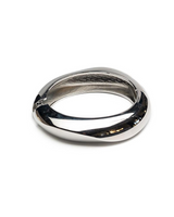 Chunky silver metal cuff with a polished finish, featuring a smooth rounded design and hollow interior.