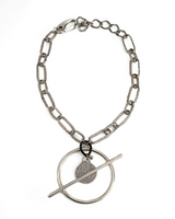 Chunky silver-plated chain necklace featuring a Phaistos disc pendant and bar closure, accented with black leather.