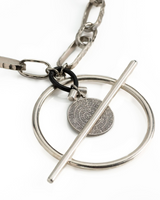 Chunky silver-plated chain necklace featuring a bar closure and a black leather element, with a Phaistos coin pendant.