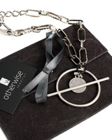 Chunky silver-plated chain necklace features a bar closure and a Phaistos disc pendant, accented with black leather.