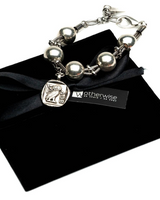 Chunky silver-plated iron cuff bracelet featuring oversized ball chain and snake chain details, presented on a black pouch.