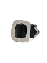 Wide black leather bracelet featuring a large silver buckle, designed for a bold, edgy style. Adjustable fit.