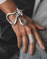 Chunky Silver Toggle Cuff bracelet worn on a wrist, featuring a heavy textured design, T-bar toggle clasp, and drop pendant.