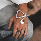 Chunky Silver Toggle Cuff featuring a heavy silver design with a T-bar toggle clasp, worn on a model's wrist with casual attire.