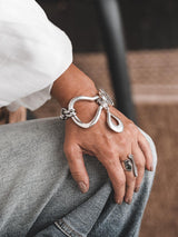 Chunky Silver Toggle Cuff worn on a wrist, featuring a bold, textured design with a T-bar toggle clasp and a large drop pendant.
