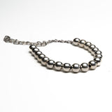Chunky silver ball chain choker with linked chain extender, offering adjustable styling and a sculptural statement look.