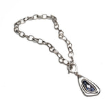 Chunky silver chain necklace with a lavender Swarovski crystal pendant, featuring a toggle clasp for secure closure.